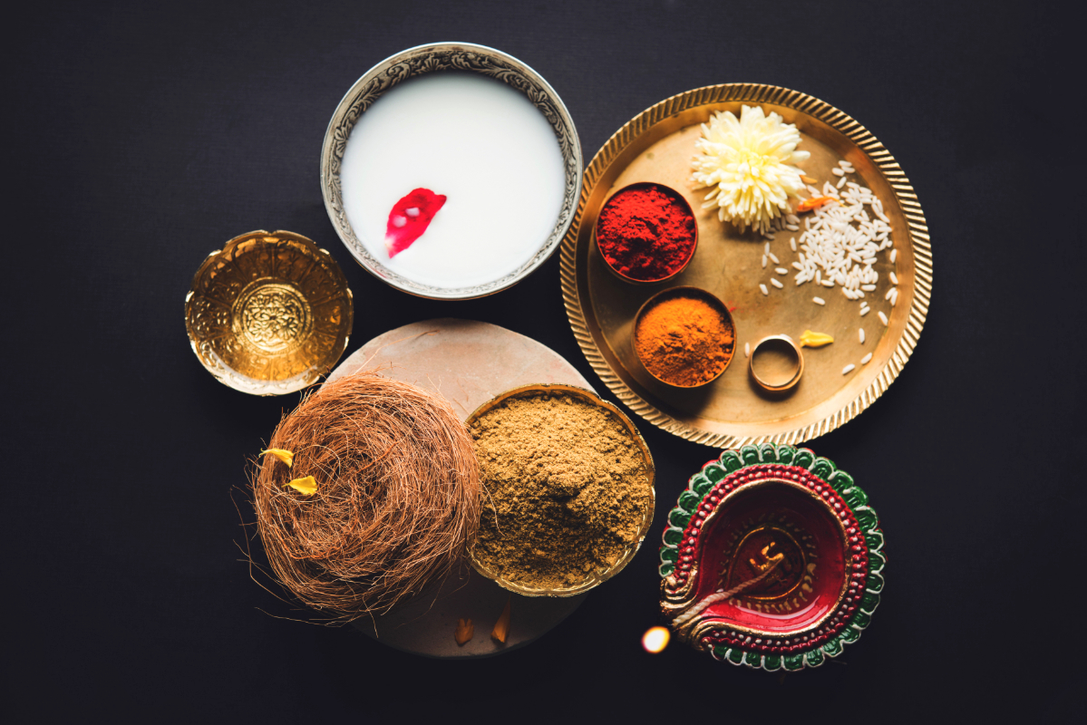 diya lamp next to other indian ritual items